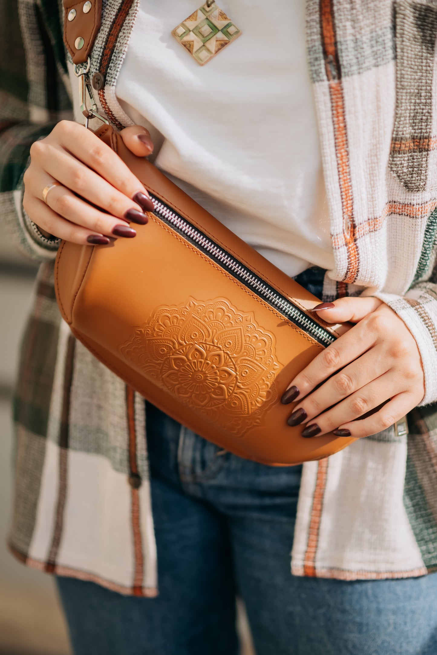 Leather banana bag with floral embossing